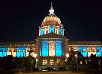 state-builindg-lit-blue-for-pf-awareness-month