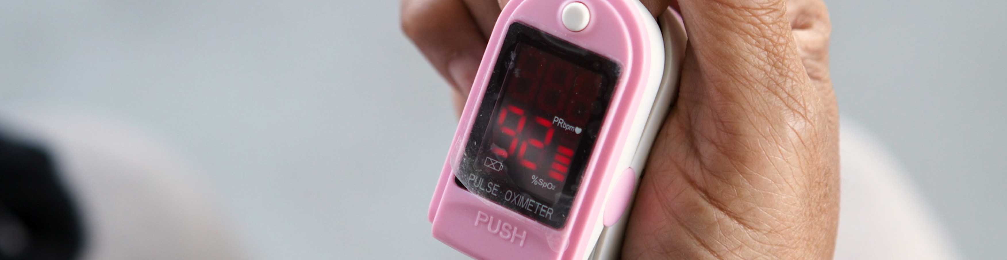 woman-checking-pulse-oximeter