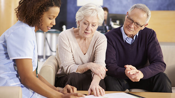 nurse-talking-to-patient-and-caregiver