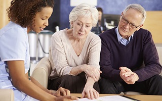 nurse-talking-to-patient-and-caregiver