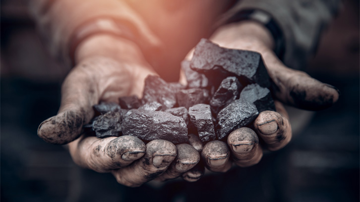 coal-worker-holding-coal-in-his-hands