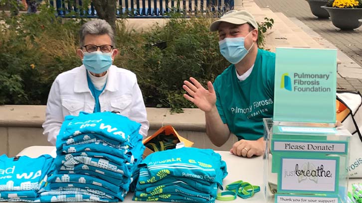 two-people-selling-tshirts-at-a-fundraiser