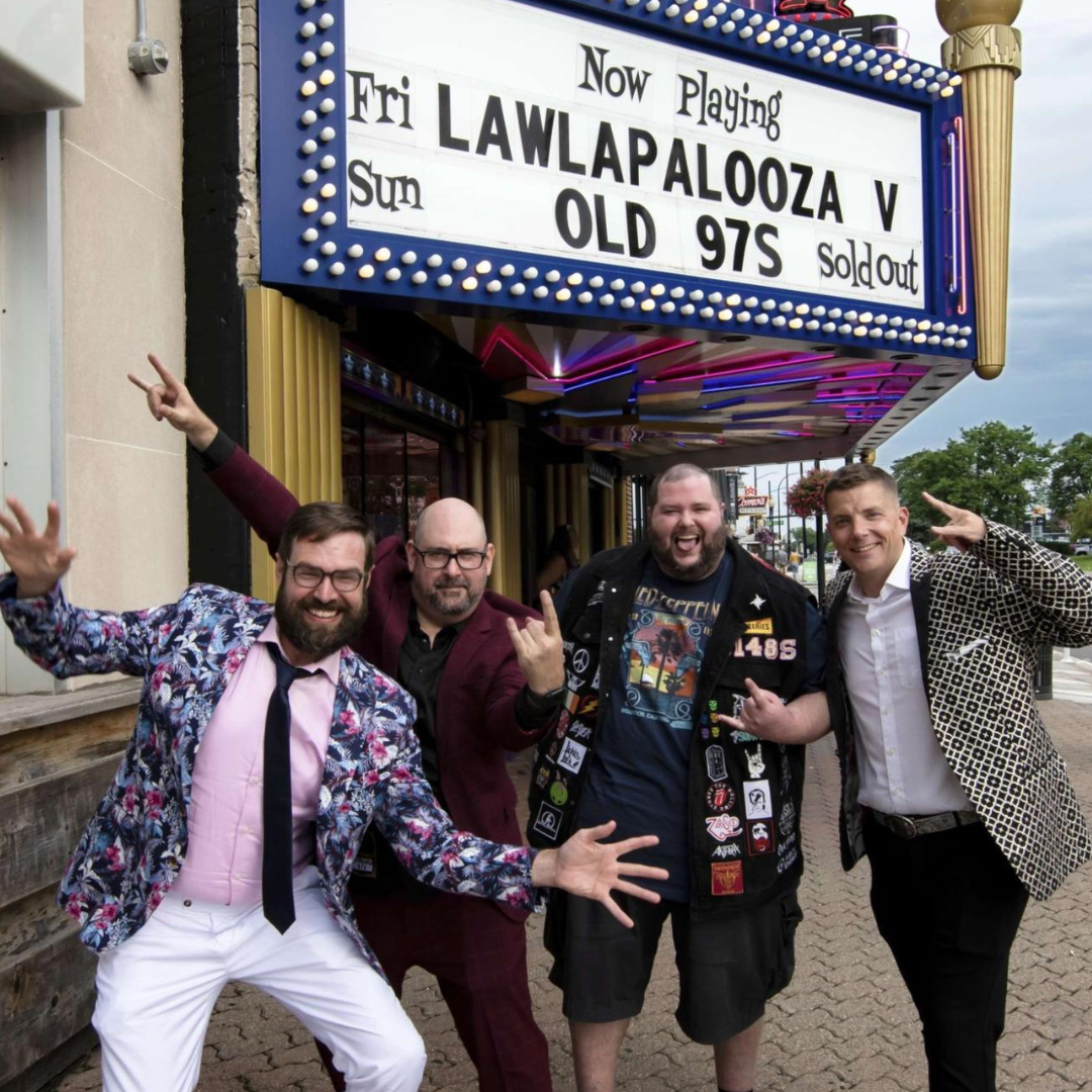 Perfomers posing in front of theater