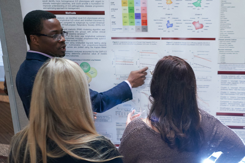 woman-presenting-poster-to-group