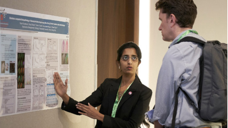 researcher-explaining-an-academic-poster