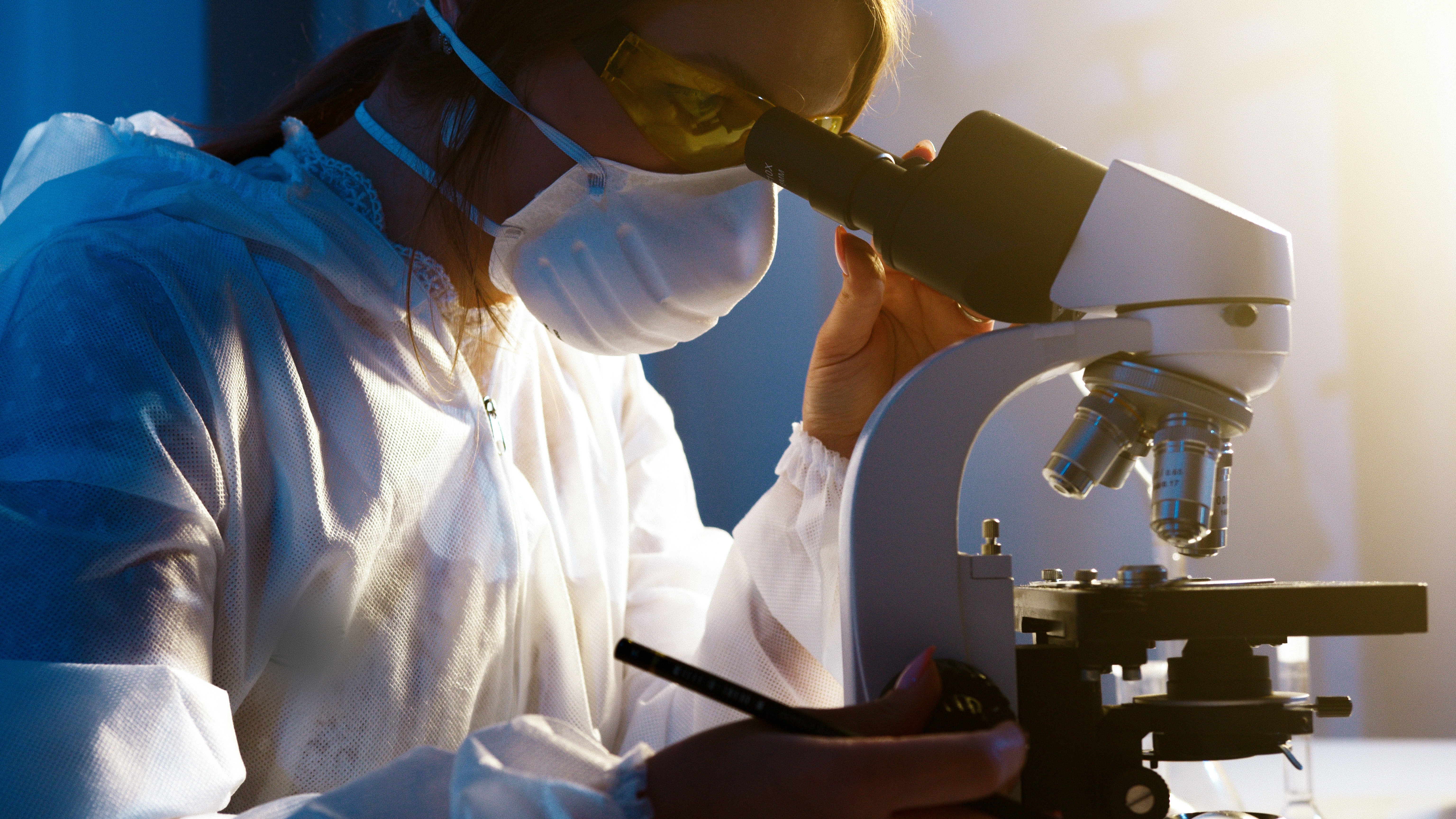 researcher-looking-through-microscope