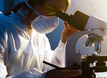 researcher-looking-through-microscope