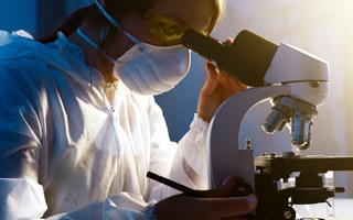 researcher-looking-through-microscope