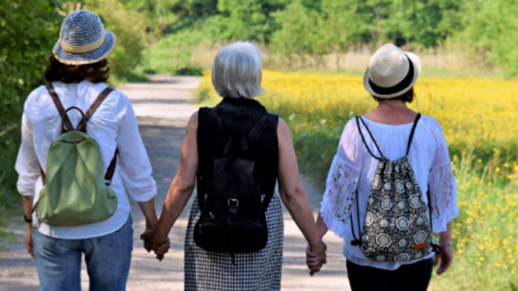 three-women-walking-on-a-nature-trail