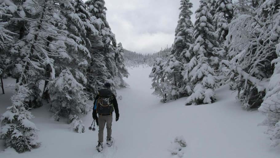 Adam Faatz hiking in the snow